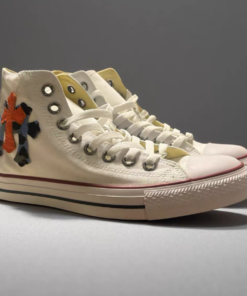 Alternative view of White Converse shoes with orange and blue camouflage patterns on the upper.