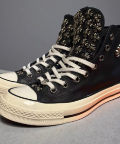 Black Converse sneakers, with many Chrome Hearts hardware studs adorning the upper.