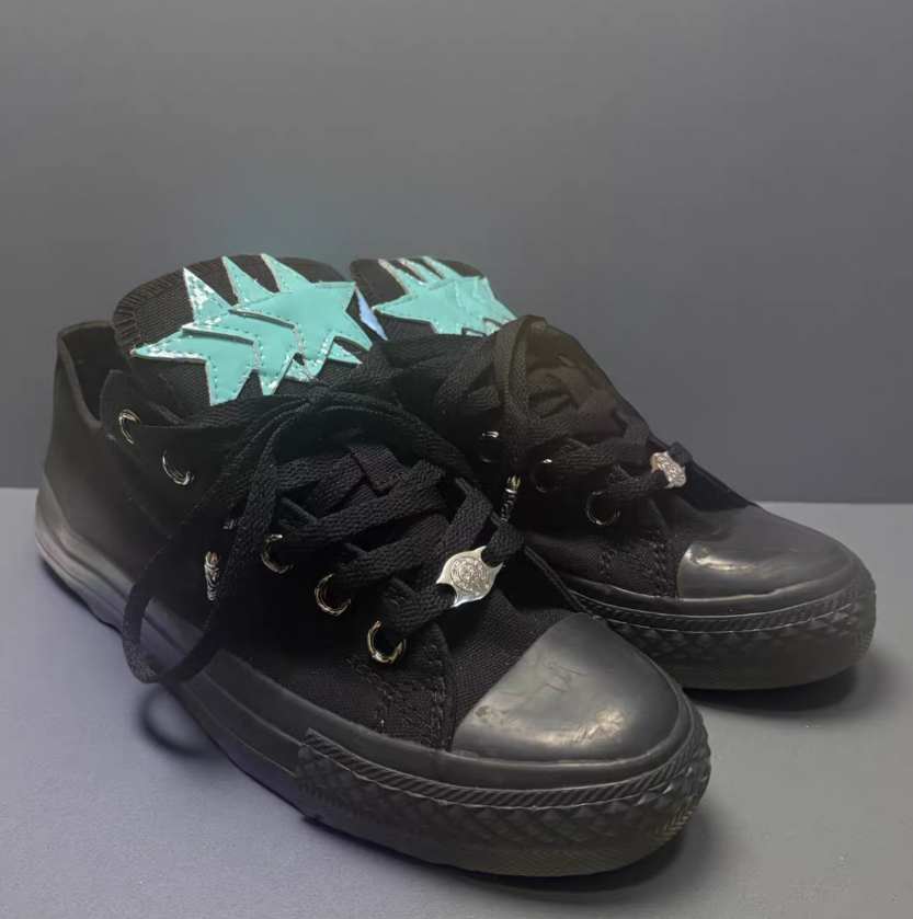 Black Converse shoes with blue star pattern