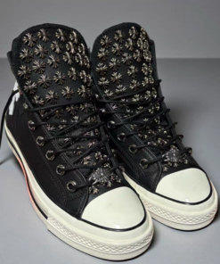 Black Converse sneakers, with many Chrome Hearts hardware studs adorning the upper