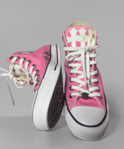 Pink Converse shoes with a white cross pattern on the upper