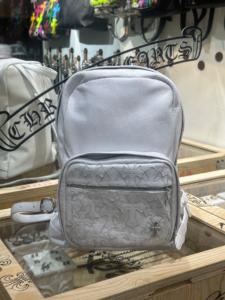ChromeHearts+ White Cross-Panel Leather Backpack. Made of cowhide leather with 925 sterling silver platinum-plated hardware, featuring a cross-pattern zipper and silver buckle on the shoulder strap